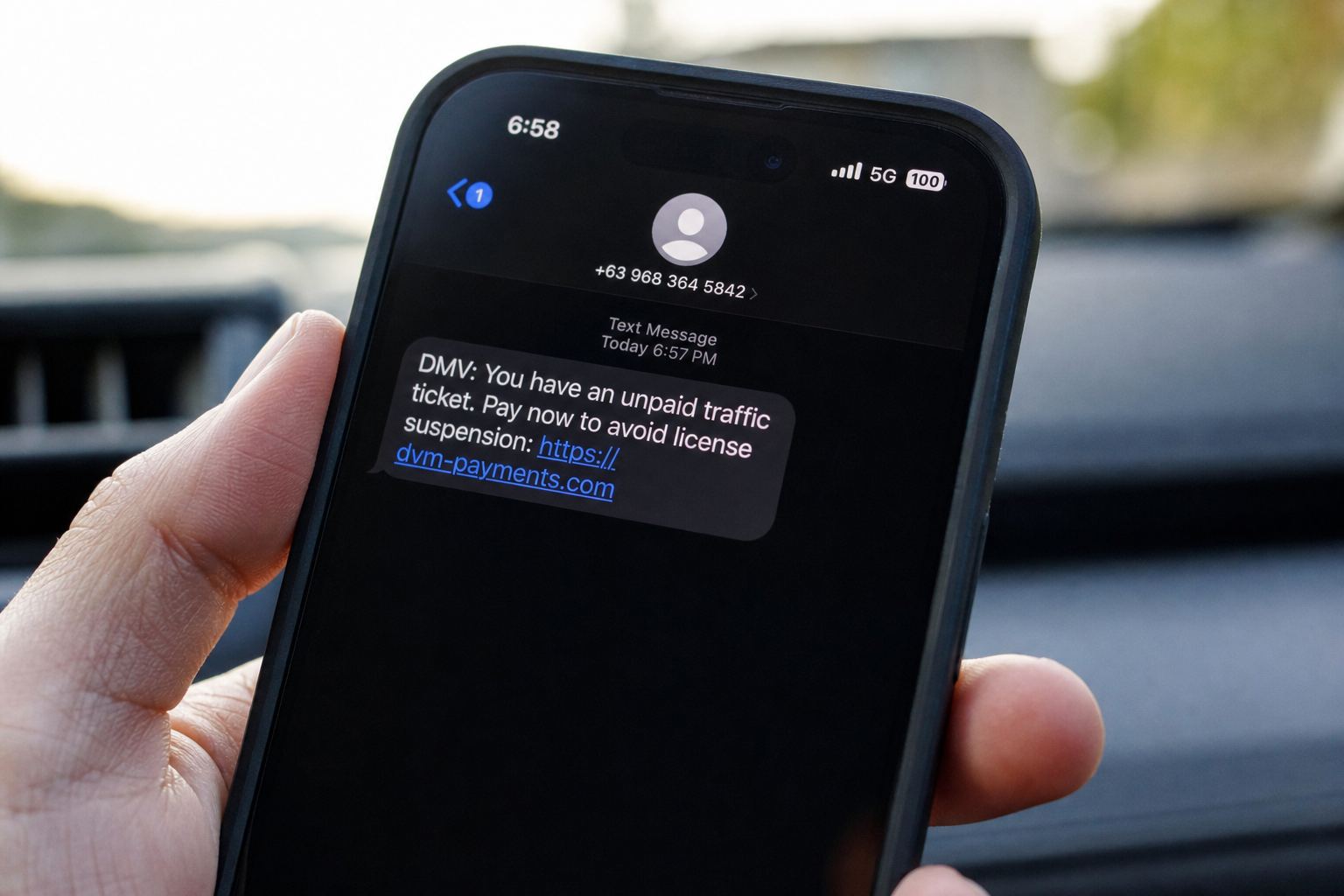 A phone showing a DMV unpaid-ticket text with a pay link.
