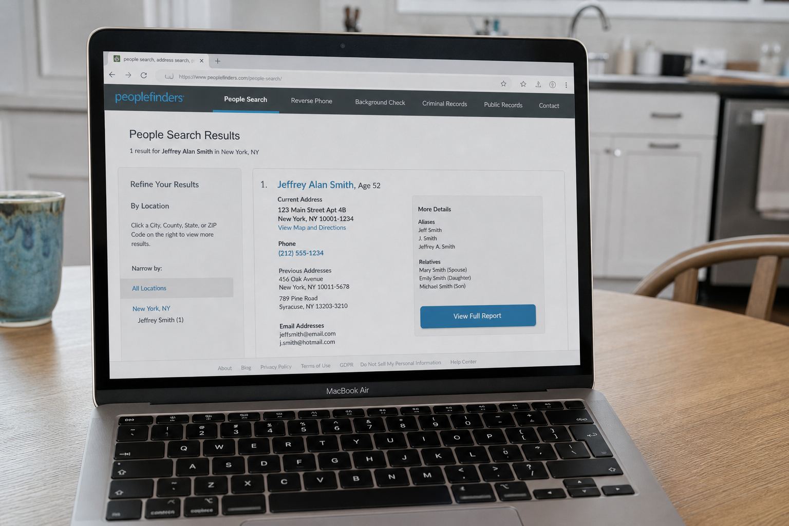 A laptop showing a people-search listing with a name, phone and address.
