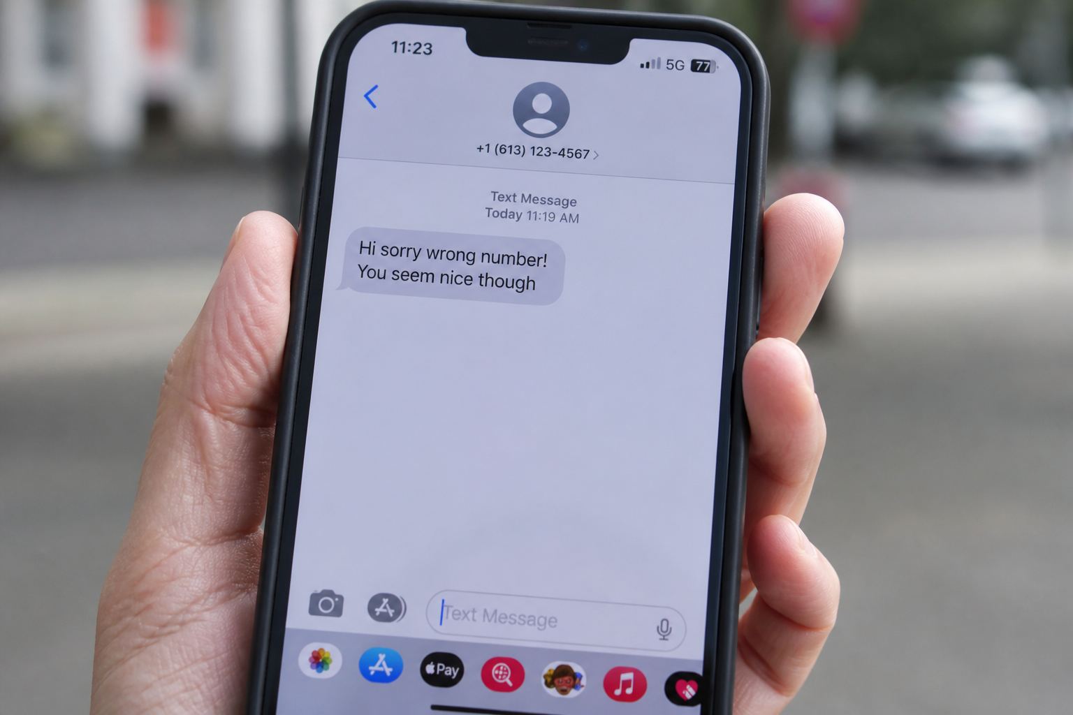A phone showing a friendly sorry-wrong-number text.